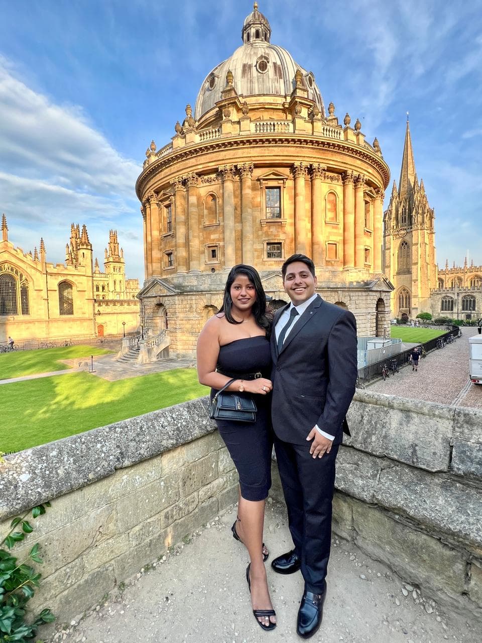 Soniya Gupta-Rawal and Shivam Rawal standing together in front of the Radcliffe Camera in Oxford